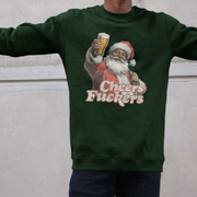 A person wearing a dark green sweatshirt featuring a vintage-style Santa holding a beer and the text