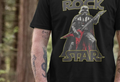 A person stands in a forest, wearing a black t-shirt featuring an illustration of a sci-fi character playing a red electric guitar, with the words "Rock Star" above and below.