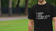 Man wearing a black sarcastic T-shirt with humorous white text: