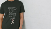 Woman wearing a black rude T-shirt with playful text