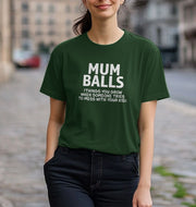 A woman on a cobblestone street wears a green t-shirt with bold white text:
