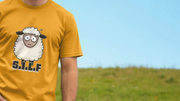 A person in a mustard-yellow funny animal T-shirt with a cartoon sheep and letters