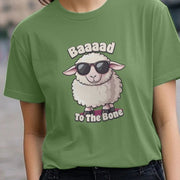 A woman wears a green Animal T-shirt featuring a cartoon sheep with sunglasses. The text reads