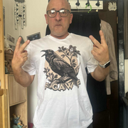 Customer photograph featuring a Bald man wearing glasses and a white Fcawf T-shirt with a crow design and funny slogan