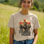 A smiling woman in a sunny field wears a beige Sports T-shirt with roaring lions and