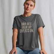 A woman in a gray relaxed fit Mum Slogan t-shirt with the words 