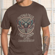 A man wears a brown horror T-shirt featuring a detailed moth with a skull design. Text reads 