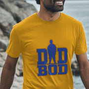 Smiling man wearing a yellow Dad T-shirt with blue 