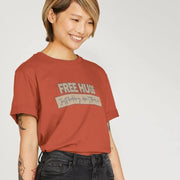 Smiling Woman with short hair wearing a red Slogan T-shirt that reads 