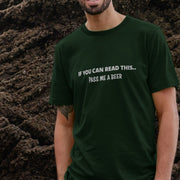 A man wearing a dark green beer t-shirt with the text 