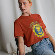 A Woman wearing a rust-colored Gaming T-shirt with cartoon character and 