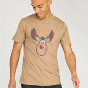 Man wearing a beige funny Christmas T-shirt with a cartoon reindeer design, featuring large antlers and a red nose. He smiles and looks down, exuding a playful vibe.