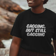 Woman smiling, wearing a black rude women's T-shirt with the playful text 