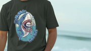 Person wearing a black funny animal t-shirt with a shark graphic and text 