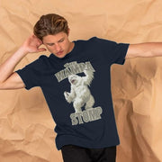 A man in a navy blue Geek T-Shirt featuring a playful white creature with text 