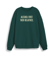 green christmas sweater with the slogan 'alcohol first then relatives'