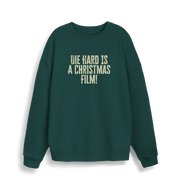 green christmas jumper with the slogan 'die hard is a christmas film'