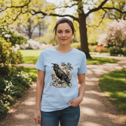 Woman wearing a light blue t-shirt with a bird design in a park