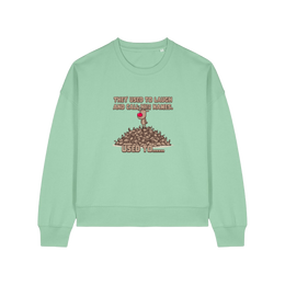 green christmas sweater with the graphic of rudoph stood ontop of a pile of reindeer and the slogan 'they used to laugh and call him names used to ..'